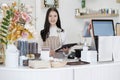 Happy Coffee Shop owner in an apron standing near a bar counter. Small business owner opening a small business. Royalty Free Stock Photo