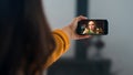 Happy colleagues calling video conference on mobile phone. Hands holding cell Royalty Free Stock Photo