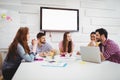 Happy colleagues discussing in meeting at creative office Royalty Free Stock Photo