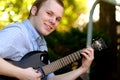 Happy College Boy with Guitar Royalty Free Stock Photo