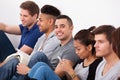 Happy College Student Sitting With Classmates Royalty Free Stock Photo