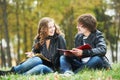 Happy college students on campus lawn outdoors Royalty Free Stock Photo