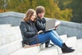 Students studying online with laptop computer outdoors Royalty Free Stock Photo