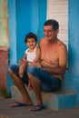 Happy Colonial Caribbean town people old man and child with classic house and wall in Trinidad, Cuba, America. Royalty Free Stock Photo