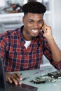 Happy computer technician consulting user on phone Royalty Free Stock Photo