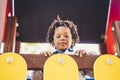 Happy concept with black children portrait at the park - happiness and playful three years old african kid looking with curiosity