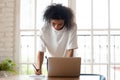 Biracial female employee make notes working on laptop Royalty Free Stock Photo