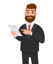 Happy confident business man holding or using a tablet computer. Royalty Free Stock Photo