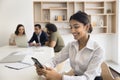 Happy confident business professional girl using smartphone over table Royalty Free Stock Photo