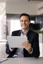 Happy confident business professional man using application on tablet Royalty Free Stock Photo