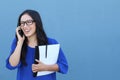 Happy confident businesswoman talking on the mobile cell phone isolated on blue Royalty Free Stock Photo