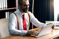 Happy confident caucasian Bearded man doing online shopping with laptop and credit card sitting on desk at home office Royalty Free Stock Photo