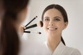 Happy confident girl putting makeup on beautiful face Royalty Free Stock Photo