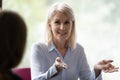 Happy confident mature businesswoman speaking, negotiating on deal at meeting Royalty Free Stock Photo