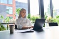 Confident mid age Asian businesswoman working typing using pc laptop. Royalty Free Stock Photo