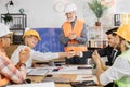 Happy construction team shaking hands during conference at office. Royalty Free Stock Photo