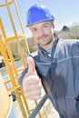 Happy construction worker gesturing thumbs up outdoors Royalty Free Stock Photo