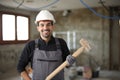 Happy construction worker posing in a house under renovation Royalty Free Stock Photo