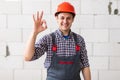 Happy constructor doing ok sign gesture as great building services concept
