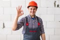 Happy constructor doing ok sign gesture as great building services concept Royalty Free Stock Photo