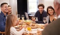 Happy, conversation and family at dinner in dining room for party, celebration or event at modern home. Smile, bonding Royalty Free Stock Photo