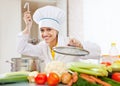 Happy cook in uniform tests vegetarian soup