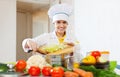 Happy cook works with vegetables Royalty Free Stock Photo