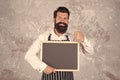 happy cooking in kitchen. restaurant chef cuisine. brutal bearded man with blackboard. hipster cook or barista show