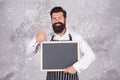 Happy cooking in kitchen. restaurant chef cuisine. brutal bearded man with blackboard. hipster cook or barista show