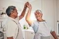 Happy, cooking and senior couple dancing in the kitchen together and feeling love, excited and bonding in home. Care