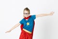 Happy and cool blond supergirl with glasses and red robe und blue shirt is posing in the studio Royalty Free Stock Photo