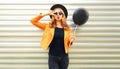 happy cool girl model blowing red lips sends air kiss, holding black air balloon Royalty Free Stock Photo