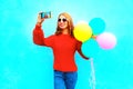 Happy cool girl takes a picture self portrait on a smartphone Royalty Free Stock Photo