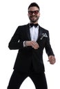 Happy cool guy in tuxedo holding hands in a fashion pose Royalty Free Stock Photo