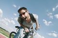 Happy cool hipster guy with bicycle having fun. Summer bike travel adventure in nature. Sexy positive man with excited face