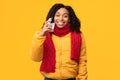 Happy Coronavirus Recovered African Woman Taking-Off Face Mask, Yellow Background