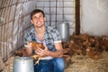 Happy countryman holding brown chicken