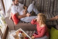 Happy couole enjoy leisure indoor activity at home together with love and relaxed time - man sitting on the couch and wife on the