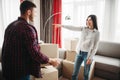 Happy couple arrange cardboard boxes on a room