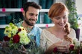 Happy couple arranging flowers