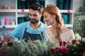 Happy couple arranging flowers