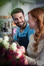 Happy couple arranging flowers