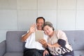 Happy couple asian senior retired using mobile tablet application technology for social network among friends community via