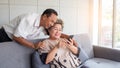 Happy couple asian senior retired using mobile tablet application technology for social network among friends community via