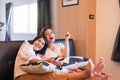 Happy couple asian woman watching TV feeling having fun together at home Royalty Free Stock Photo