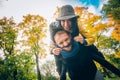 Happy Couple Having Fun in Autumn Park. Yellow Trees and Leaves. Laughing Man and Woman outdoor. Freedom Concept. Royalty Free Stock Photo