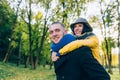 Happy Couple Having Fun in Autumn Park. Yellow Trees and Leaves. Laughing Man and Woman outdoor. Freedom Concept. Royalty Free Stock Photo