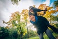 Happy Couple Having Fun in Autumn Park. Yellow Trees and Leaves. Laughing Man and Woman outdoor. Freedom Concept. Royalty Free Stock Photo