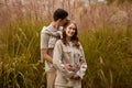 Happy couple on autumn walk outdoors. Two lovers in autumn park. Love and tender touch. Gentle hugs. Young man and woman Royalty Free Stock Photo