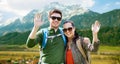 Happy couple with backpacks traveling in highlands Royalty Free Stock Photo